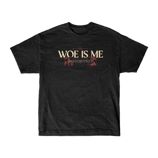 The Woe Is Me black womens-inspired T-shirt features WOE IS ME in bold cream letters with red and cream ornamental lines below, shown on a plain white background.