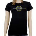A woman wears a black Mantralogy Womens T-Shirt featuring 24 Hour Kirtan in the center, encircled by a yellow and white design with decorative text in another language, inspired by West Virginia’s vibrant spirit.