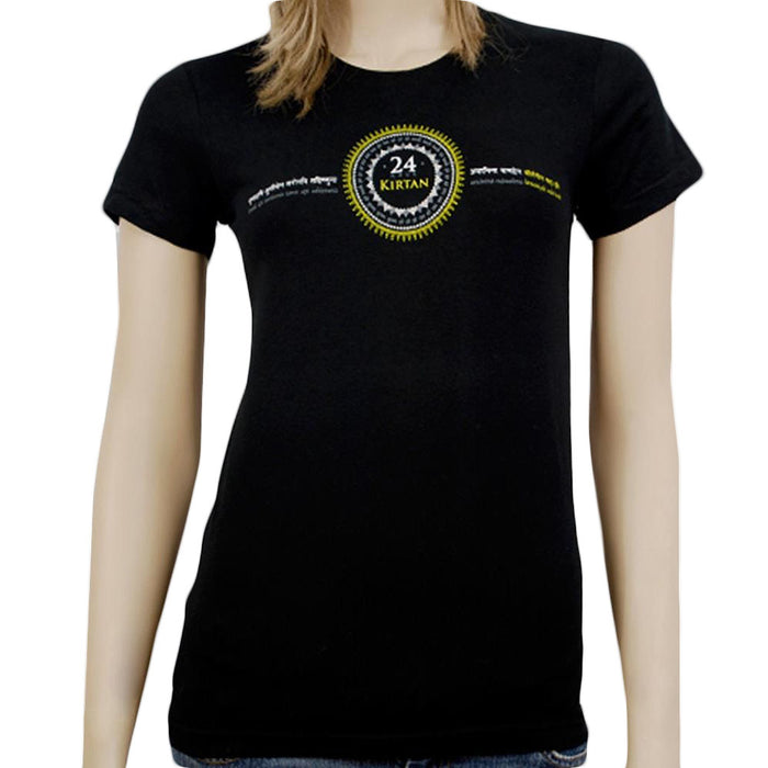 A woman wears a black Mantralogy Womens T-Shirt featuring 24 Hour Kirtan in the center, encircled by a yellow and white design with decorative text in another language, inspired by West Virginia’s vibrant spirit.