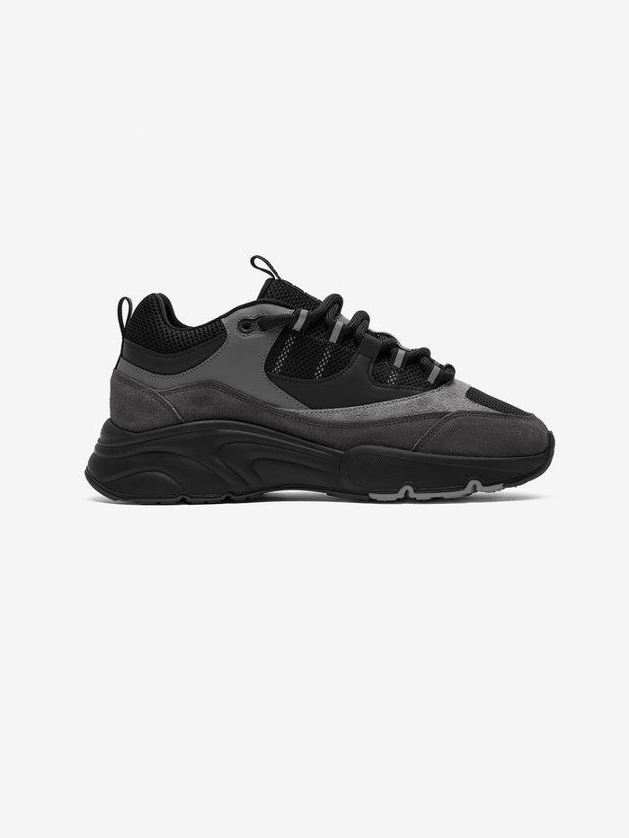 Black and grey smart trainer on a white background