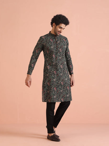The model is captured mid-walk while wearing Black Printed Cotton Silk Kurta Trouser Set of Kisah.