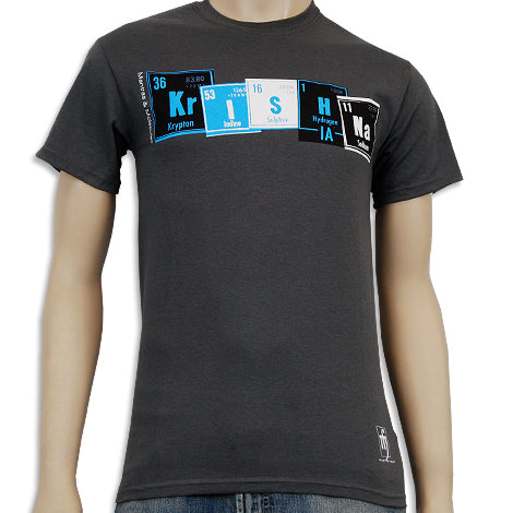 A dark gray Mantralogy T-shirt with Krishna spelled out in periodic table-style colored boxes, each letter styled like a chemical element symbol.