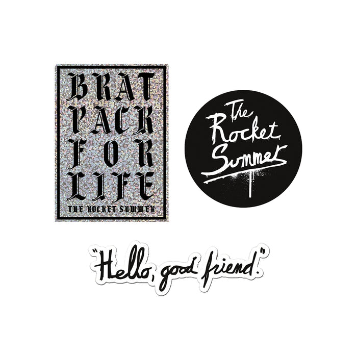 Three The Rocket Summer stickers: a glittery BRAT PACK FOR LIFE THE ROCKET SUMMER Brat Pack sticker, a round black logo sticker with white script, and a playful Hello Good Friend sticker in black cursive.