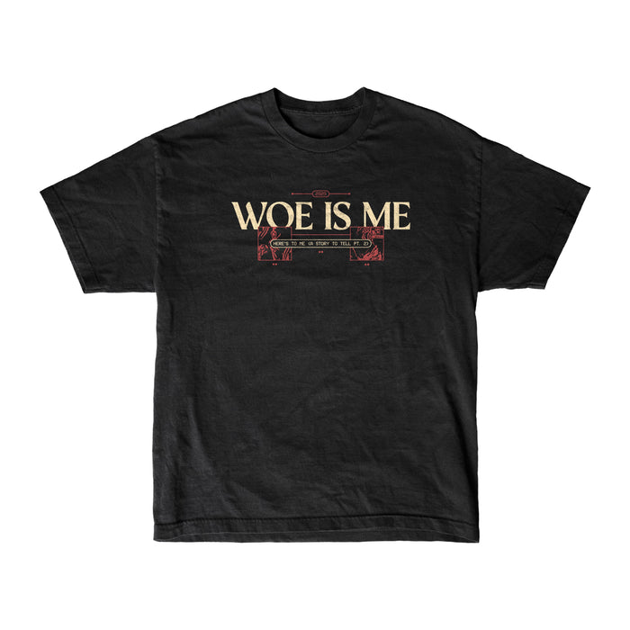 The Woe Is Me black womens-inspired T-shirt features WOE IS ME in bold cream letters with red and cream ornamental lines below, shown on a plain white background.