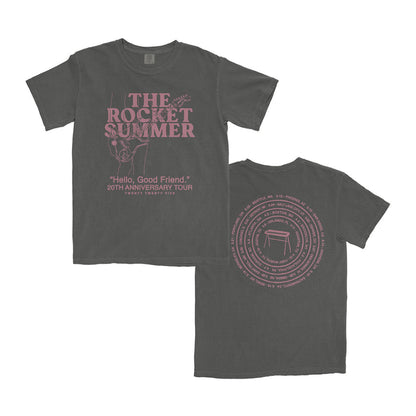 A dark gray Comfort Colors T-shirt by The Rocket Summer with pink text: THE ROCKET SUMMER and Hello, Good Friend 20th Anniversary Tour on the front; tour cities circle a table graphic on the back.