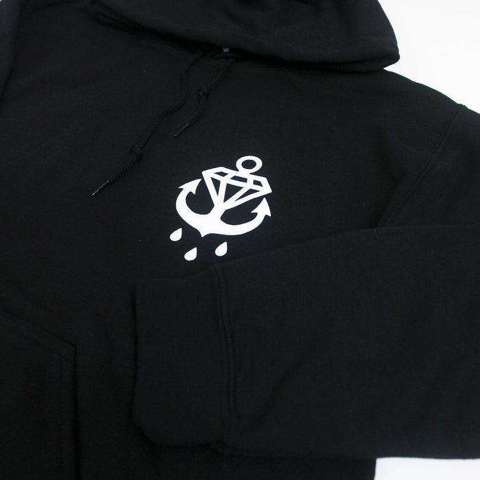 A Phase Black hoodie from Stay Sick Clothing with a white anchor, diamond, and three water droplets graphic on the left chest.