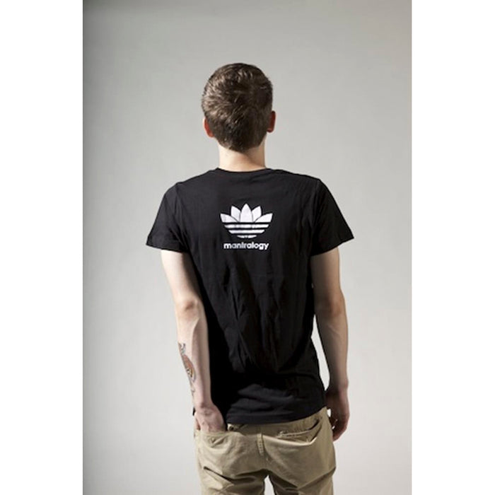 A person with short hair, seen from behind, wears a black unisex Mantralogy t-shirt with a white logo and khaki pants, channeling subtle 80s hip hop vibes against a plain light background.