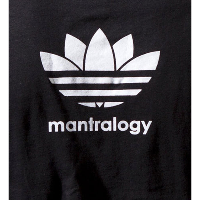 The Mantralogy unisex black t-shirt features a white, Adidas-inspired graphic with a stylized trefoil, three stripes, and mantralogy printed below—ideal for fans of 80s hip hop style.
