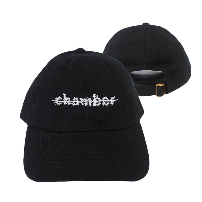 Two black Chamber baseball caps are shown; one faces forward with chamber embroidered in a white glitch-style font, while the other is backward, displaying an adjustable strap with a gold buckle.