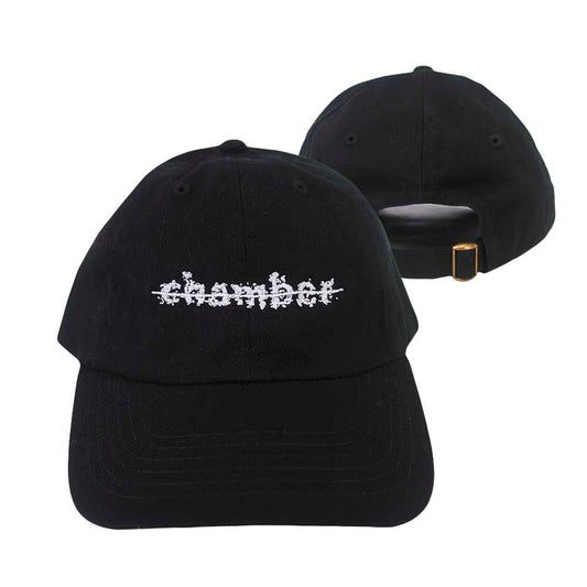 Two black Chamber baseball caps are shown; one faces forward with chamber embroidered in a white glitch-style font, while the other is backward, displaying an adjustable strap with a gold buckle.