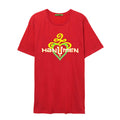 A red T-shirt by The Hanumen features a yellow and green abstract design above HANUMEN in bold white letters with yellow outlines, set over a stylized heart in red, green, and yellow.