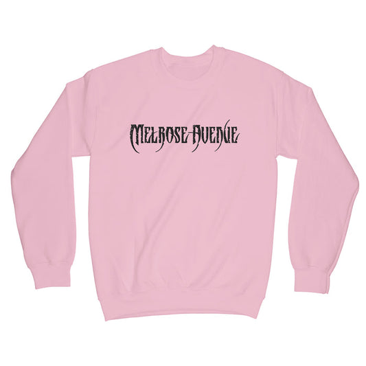 A light pink midweight crewneck sweatshirt from Melrose Avenue, featuring Melrose Avenue embroidered in bold, black gothic font across the chest.