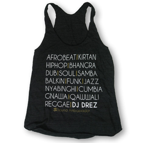 The Mantralogy black tank top features a list of music genres in white and yellow text, including Afrobeat, Kirtan, Hip Hop, Bhangra, Dub, Soul, Samba, Balkan, Funk, Jazz, Nyabinghi, Cumbia, Gnawa, Qawwali & Reggae.