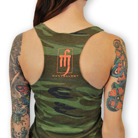 A person with colorful arm tattoos wears a green camouflage racerback tank top. The back features an orange Mantralogy logo printed below the neckline.