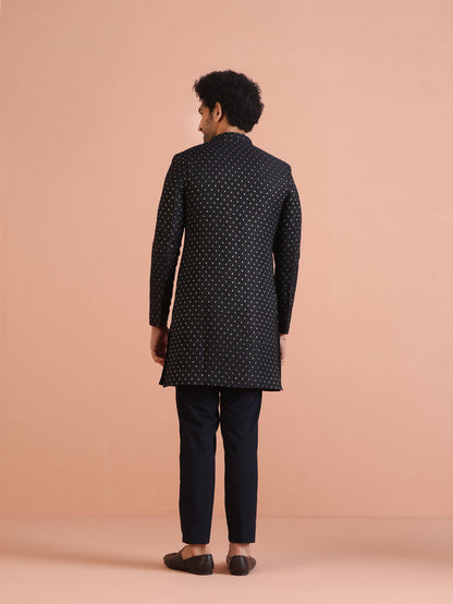 The back view of the model, wearing Kisah's  Navy Blue Embellished Indowestern Trouser Set
