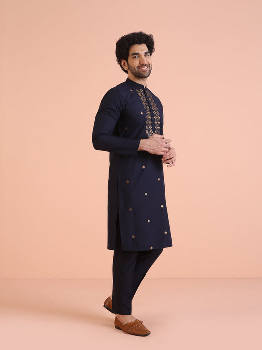 The side view of the model highlights Kisah Men’s Navy Blue Embroidered Kurta Set with detailed neckline design
