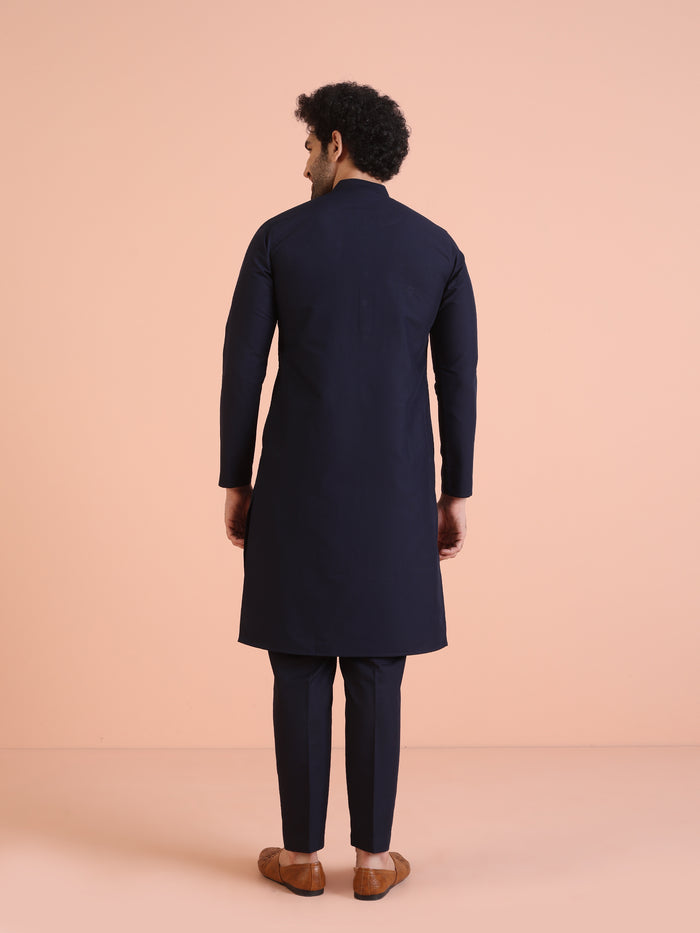 The back view of the model showcases Kisah Men’s Navy Blue Embroidered Kurta Set with a clean and elegant finish