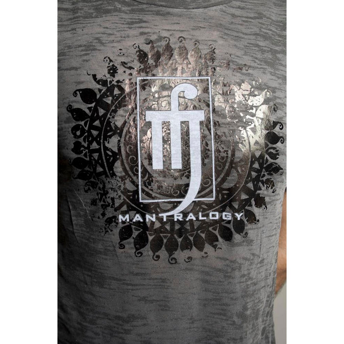 Close-up of a Mantralogy ultra-soft burnout shirt in gray, featuring a white abstract symbol, intricate mandala-style black design in iridescent foil, and the Mantralogy logo printed below.