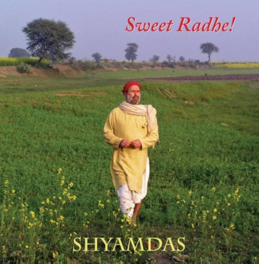A man in traditional Indian attire and a red headscarf walks through a green field under a clear sky. Sweet Radhe! is at the top, with the brand name Shyamdas at the bottom.