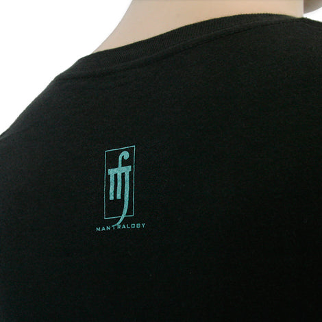 A person’s upper back and neck are shown wearing a black shirt featuring the Mantralogy brand name and turquoise logo. Only the top half of the back and part of the neck are visible.